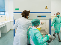 Health workers in personal protective equipment PPE are conducting COVID-19 PCR tests procedure in the laboratory of the Hellenic National B...