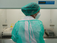 A health worker in personal protective equipment PPE is conducting COVID-19 PCR tests procedure in the laboratory of the Hellenic National B...