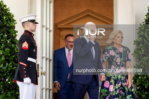 President Joe Biden puts on his aviator sunglasses as he and First Lady Dr. Jill Biden leave the Oval Office to host an event with Secretary...