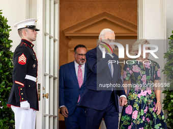 President Joe Biden puts on his aviator sunglasses as he and First Lady Dr. Jill Biden leave the Oval Office to host an event with Secretary...