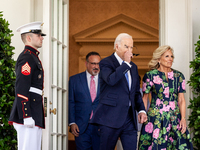 President Joe Biden puts on his aviator sunglasses as he and First Lady Dr. Jill Biden leave the Oval Office to host an event with Secretary...